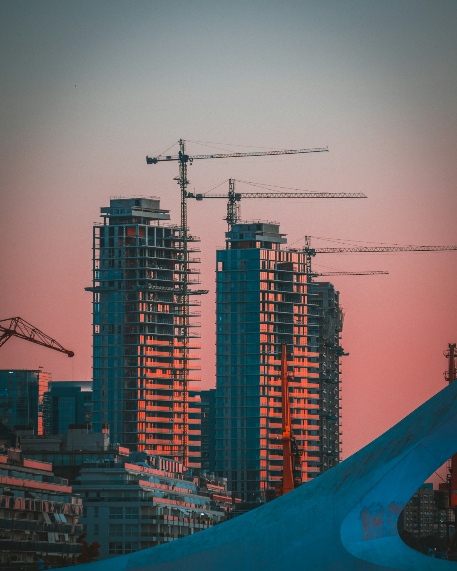 Construction crane silhouetted against the evening sky.
