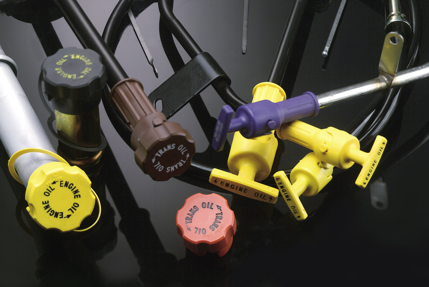 Fluid level indicator product family with assorted oil and transmission fluid handles.